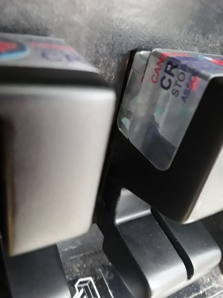 Card skimmer installed over actual card reader. The skimmer copies the information from the black magnetic stripe on the back of the card.
Suspects are using the same silver security tape as Petro Canada.
A common comment is that it is difficult to feed the card in and out.